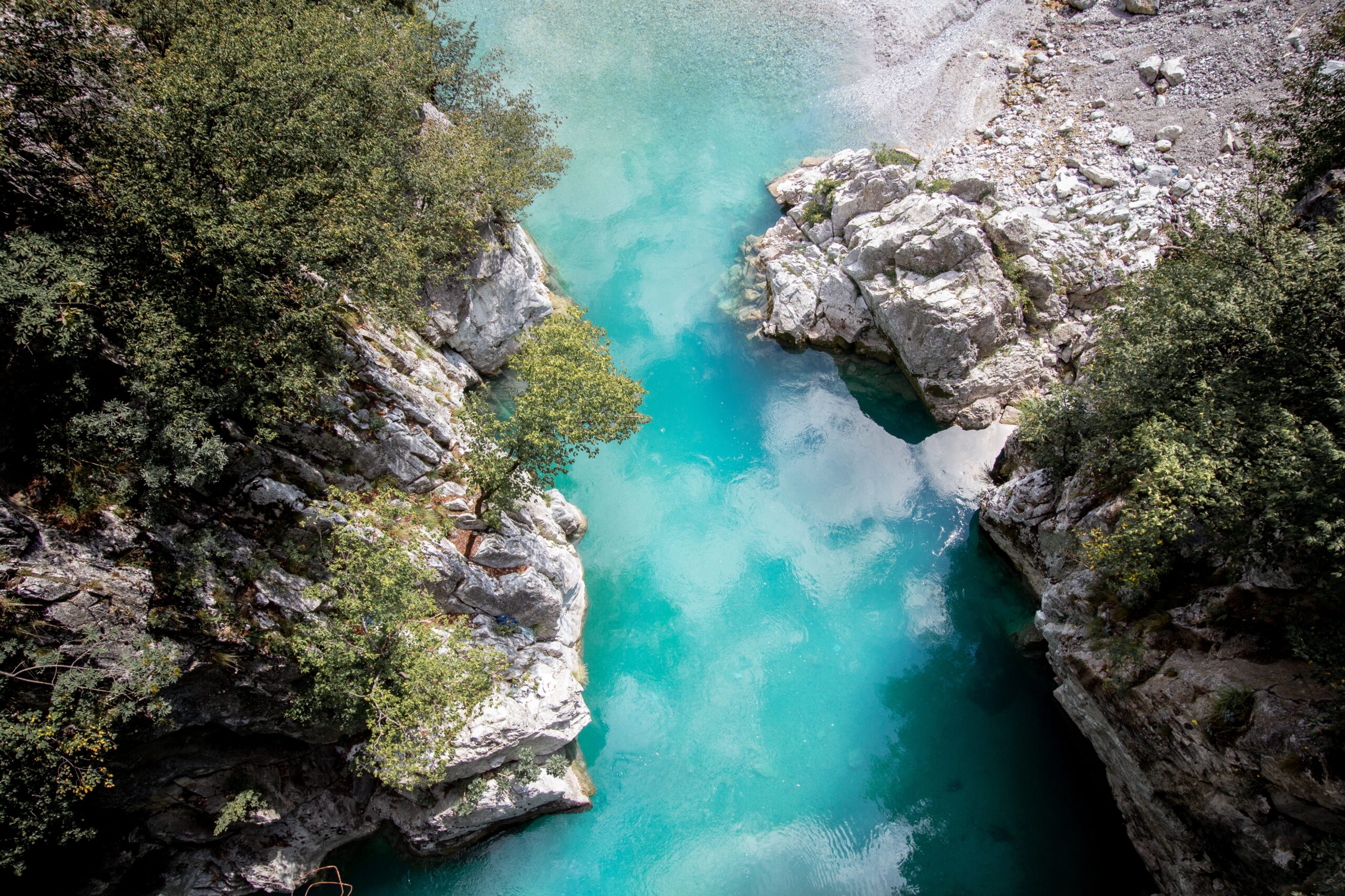 An aerial shot of the Valbona Valley National Park with reflecting waters in Albania