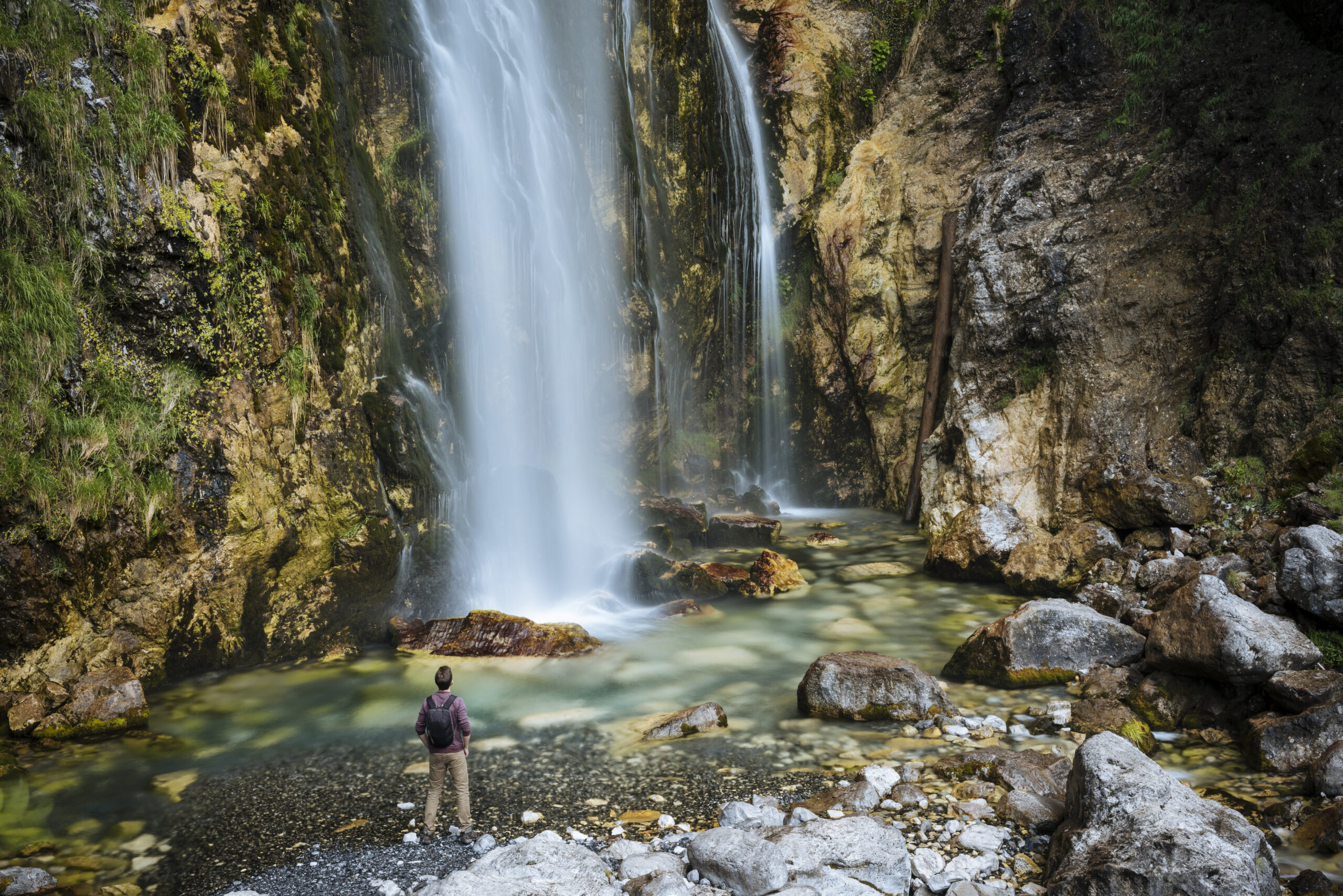 Hiker looking at waterfall, Accursed mountains, Theth, Shkoder, Albania, Europe